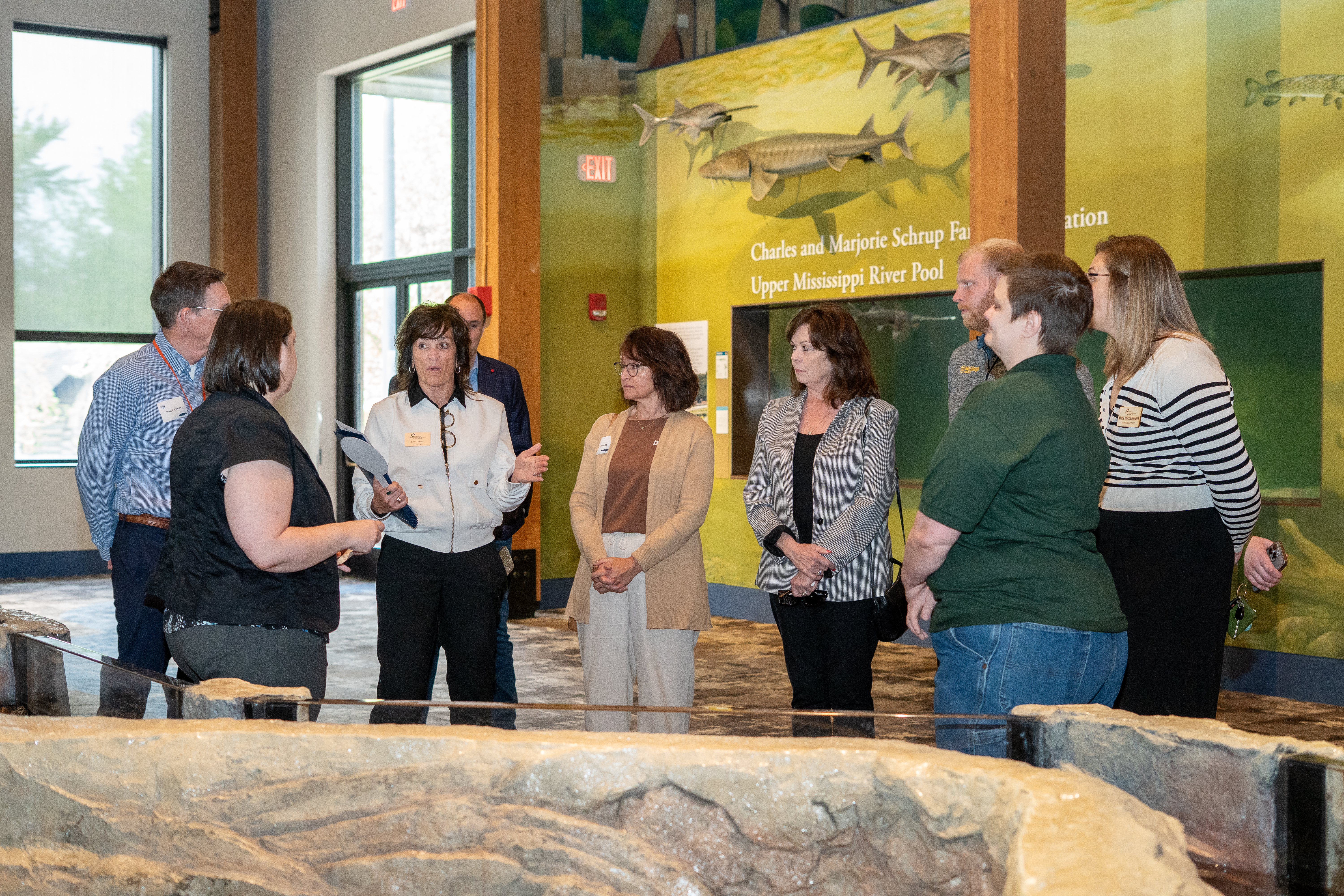 A group of guests learn about the trout stream construction