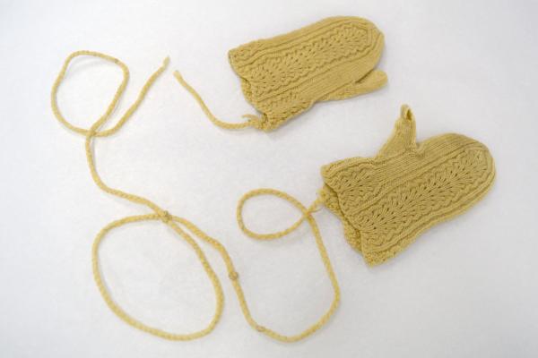 yellow mittens with a string connecting them