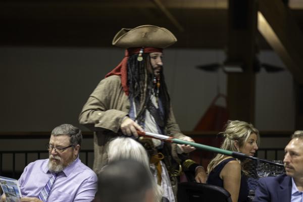 staff collecting bidding paddles