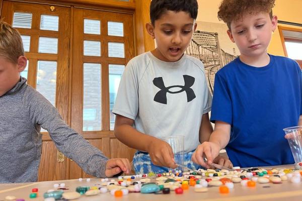 school aged summer campers doing a STEM activity