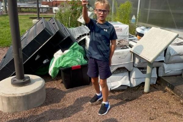 school aged summer camper at the greenhouse