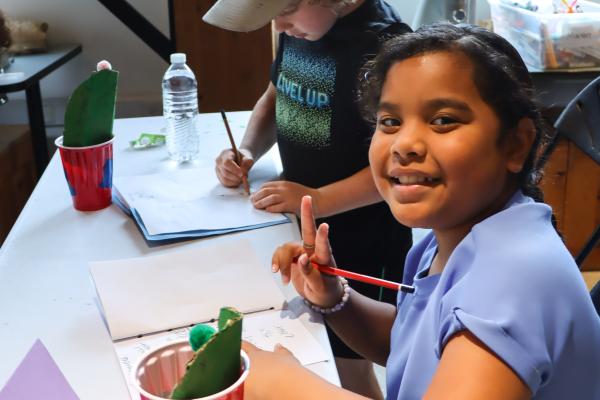 school aged summer campers doing a craft in the learning lab