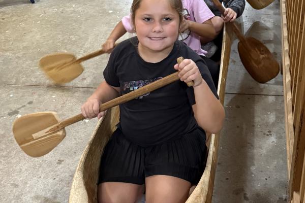 school aged summer campers in a canoe