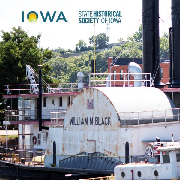 The William M. Black Steamdredge boat at the National Mississippi River Museum and Aquarium with the State Historical Society of Iowa logo