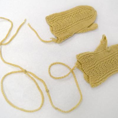 yellow mittens with a string connecting them