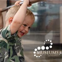 small boy looking at exhibit with Museums for All logo in the bottom right corner